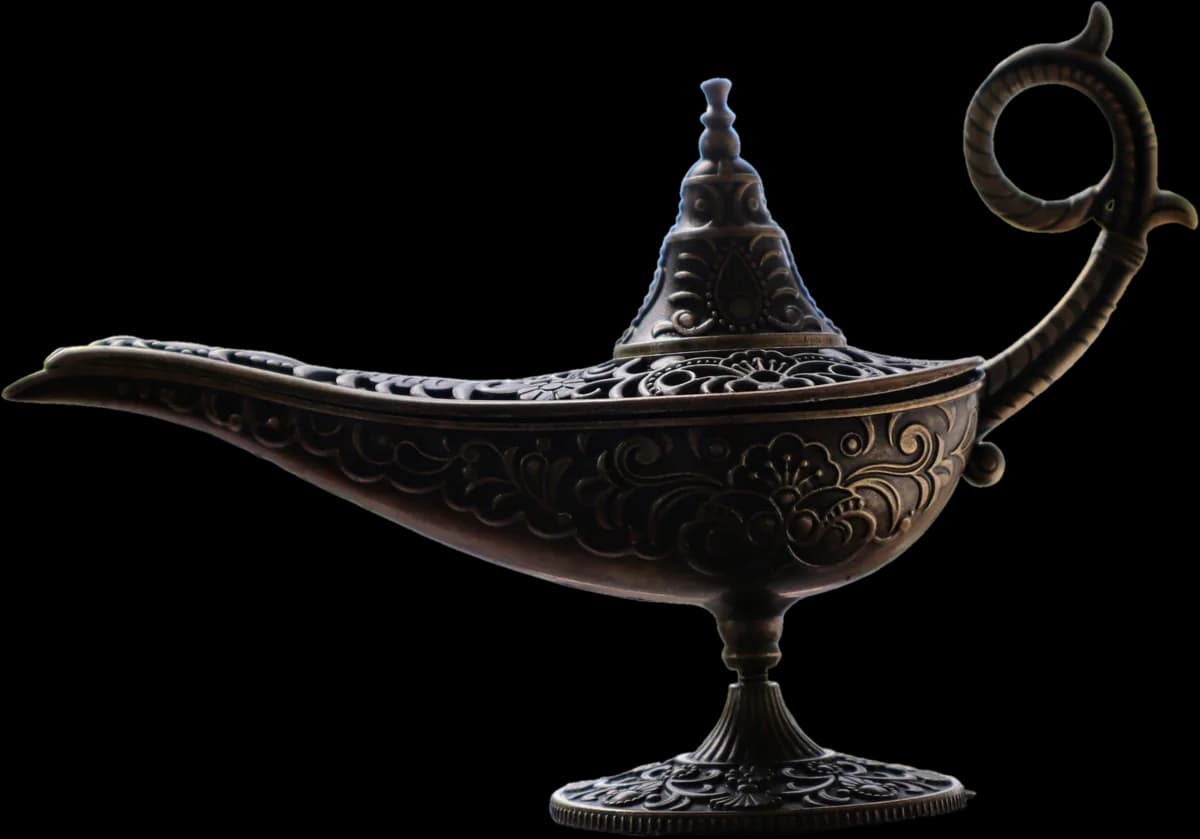 A brass oil lamp with a long spout, curled handle and engraved body