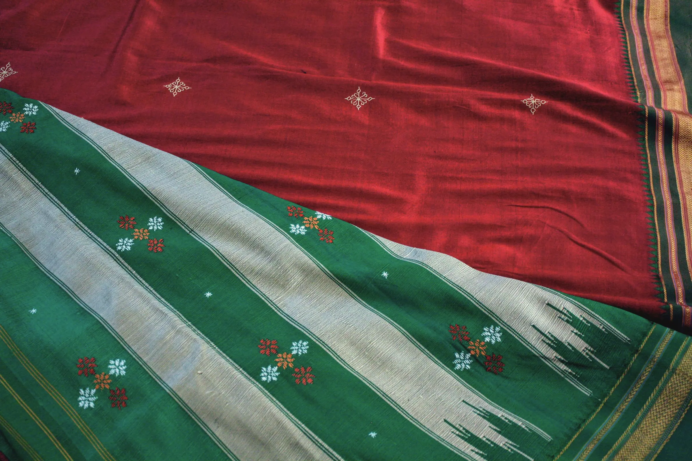 A red and green cotton sari with small white motifs